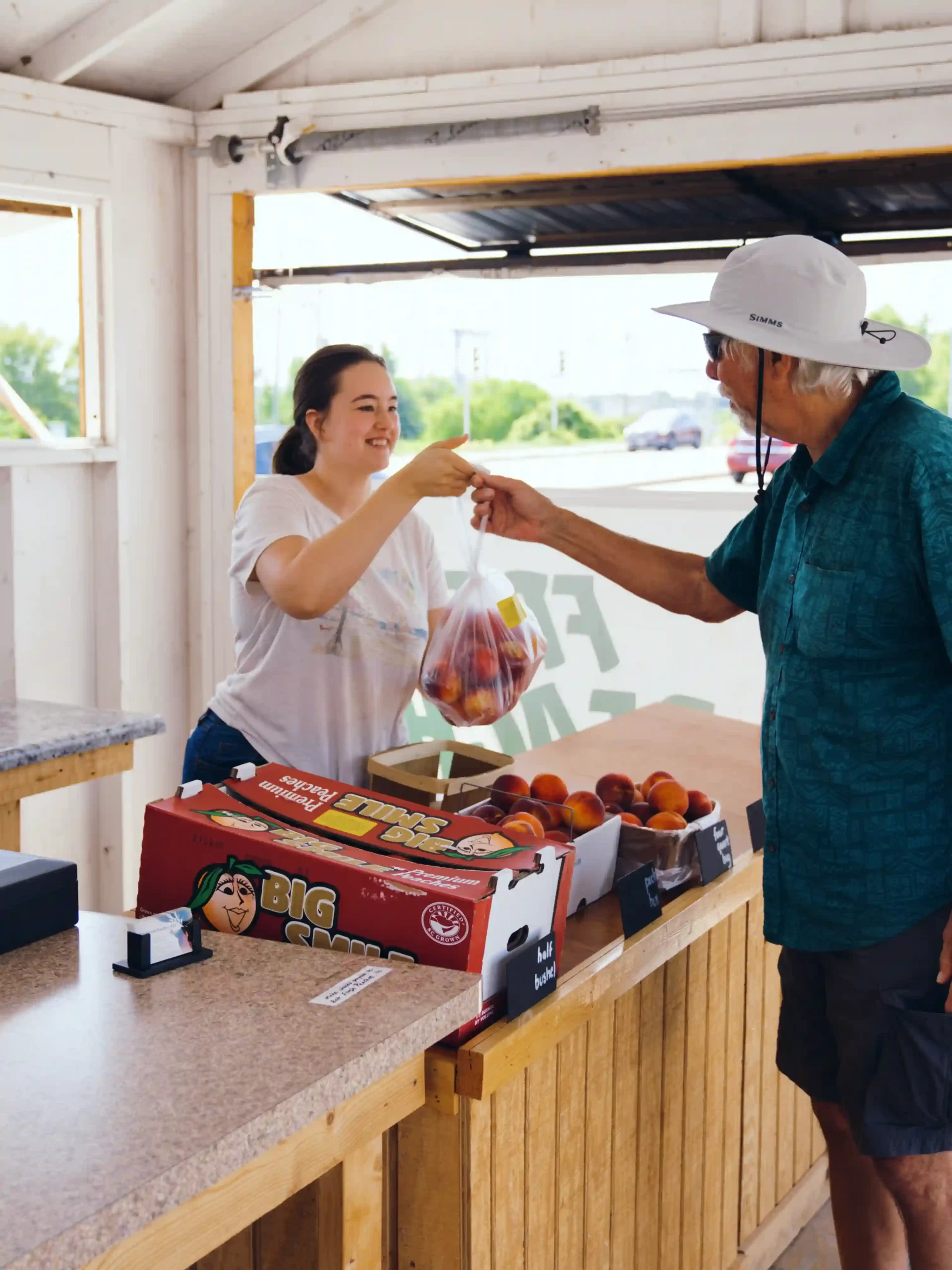 Employee Handing Customer Peaches Employee Handing Customer Peaches scaled