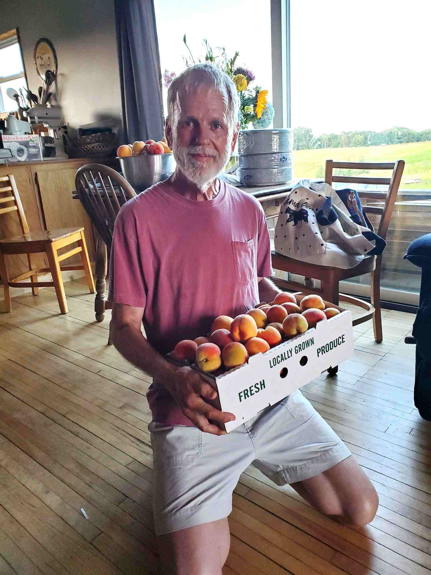 Pop holding a peck of peaches